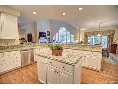 An updated kitchen with granite countertops, stain