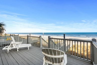 Deck with a water view and a view of the beach