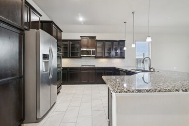 Gourmet kitchen with a built-in double oven and gr