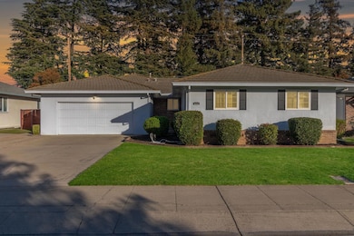 Wide front view showcasing the attached two-car garage and spacious driveway.