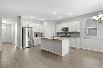 Kitchen with white cabinets, tasteful backsplash, 