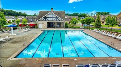 Community pool featuring a patio and a residential view