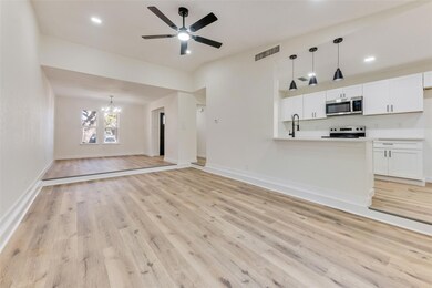 Unfurnished living room with ceiling fan with nota