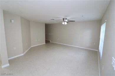 Tiled spare room featuring ceiling fan