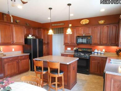 Eat-in Kitchen features center island,stained mapl