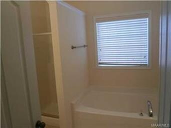 master bath with a garden tub and separate shower