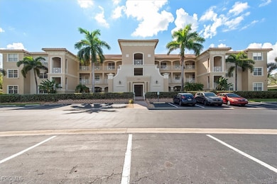 View of apartment building / complex with uncovered parking