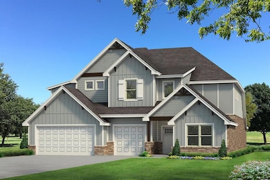 Craftsman house with a garage and a front lawn