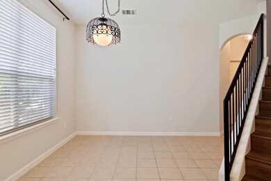 Unfurnished room with arched walkways, stairs, an