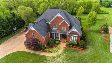 Professionally Landscaped and Irrigated Beds Leading to Covered Front Porch with Grand Double-Doored Entry.