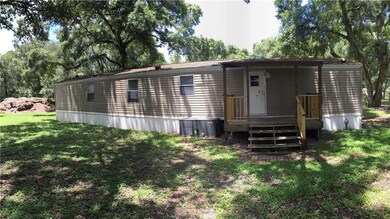 Back of home with small deck