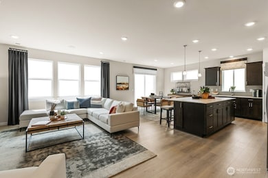 Hard surface flooring throughout main great room, kitchen, and dining. Photo rendering is representational. Actual home is under construction and finishes, elevation, and paint colors may vary. See site agent for details.