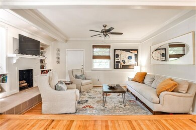 Elegant and cozy living room featuring a tray ceiling