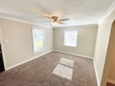 Carpeted spare room featuring ceiling fan and crow