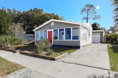 View of front of home with a garage and concrete driveway