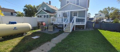 Back of house with a yard and a deck
