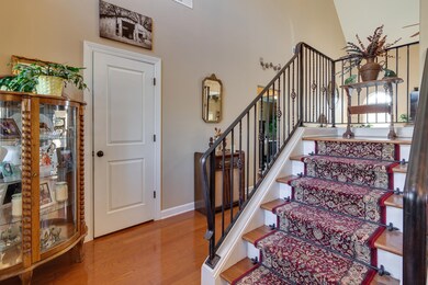 Foyer with light wood-style floors and stairs