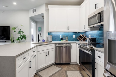 Kitchen with stainless steel appliances, a sink, 
