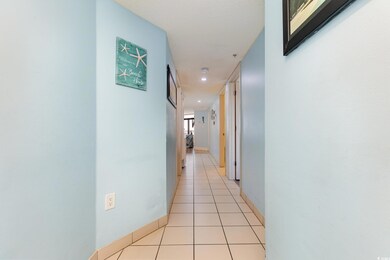 Hallway with light tile patterned floors