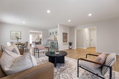 Living area with light wood-style floors and recessed lighting