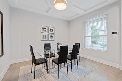 Dining space featuring baseboards, coffered ceili