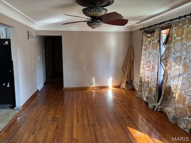 Empty room with hardwood / wood-style floors and ornamental molding