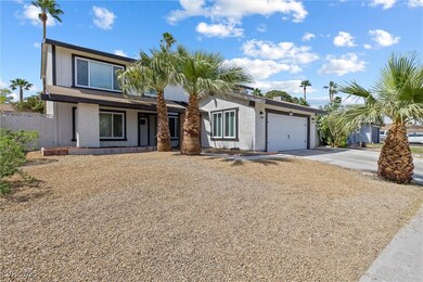 View of front of property with a garage and drivew