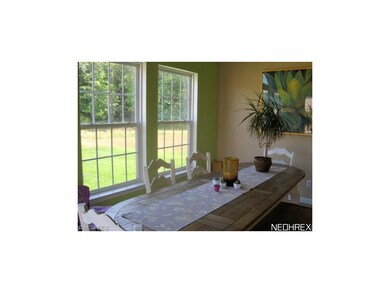 Bright morning room has large windows overlooking 