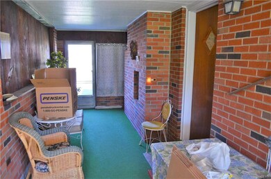 Enclosed breezeway between garage and house w/ fir