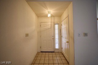 Foyer entrance with light tile patterned floors