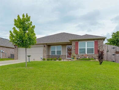 View of front of home featuring brick siding, driveway, an attached garage, and a shingled roof