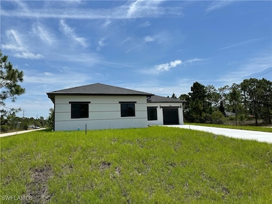 View of front of home with concrete driveway, an a