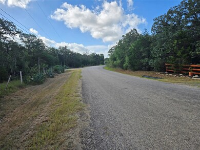 View of asphalt road with a view of trees