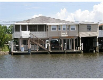 Backyard. From across the wide canal the back of t