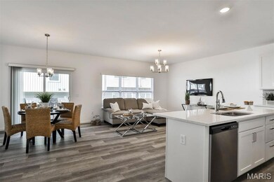 Kitchen with a chandelier, white cabinets, open floor plan, dishwasher, and dark wood-style flooring