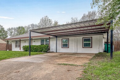 Ample parking awaits with a wide driveway.