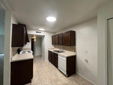 Kitchen with light tile patterned flooring, sink, 