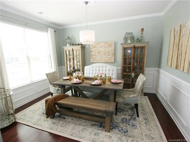Formal dining room features decorative chandelier,