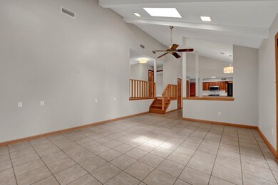 Tiled spare room with high vaulted ceiling, ceilin