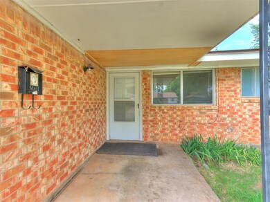View of exterior entry with a patio