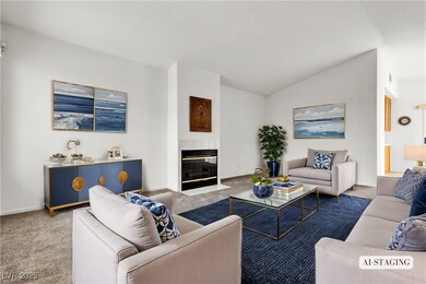 Living room with vaulted ceiling, a fireplace with