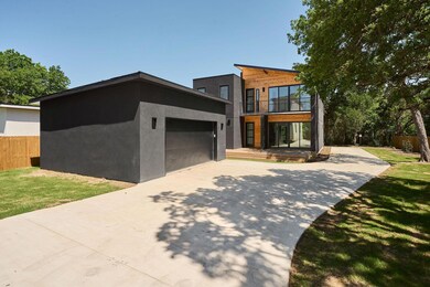 Contemporary house featuring concrete driveway, a