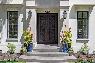 This elegant front entrance with dark iron ornate