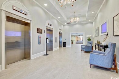 Lobby with a high ceiling, recessed lighting, and ornamental molding