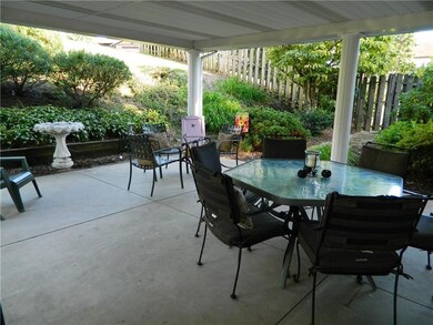 The covered patio is spacious with beautiful lands