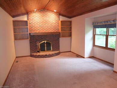 Great room with fireplace and vaulted ceiling.