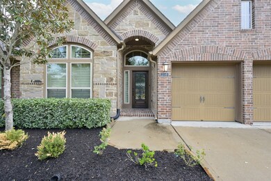 Visitors will enter this beautiful home through an impressive covered entry and an elegant wood and leaded glass door.