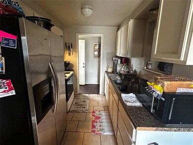 Kitchen featuring a sink, light tile patterned flo