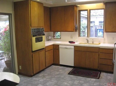 Rich wood cabinets, skylights, layered lighting an