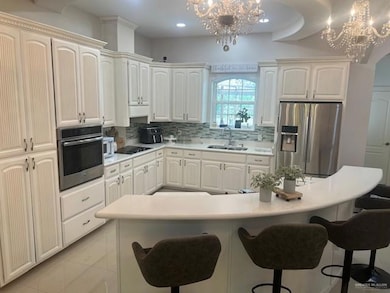 Stainless steel appliances, backsplash, and sink